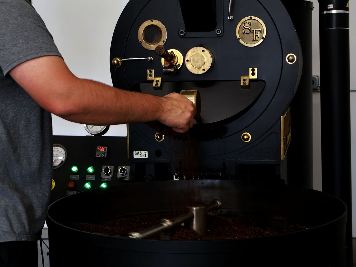 Dropping a finished roast from the San Franciscan roaster into the cooling tray