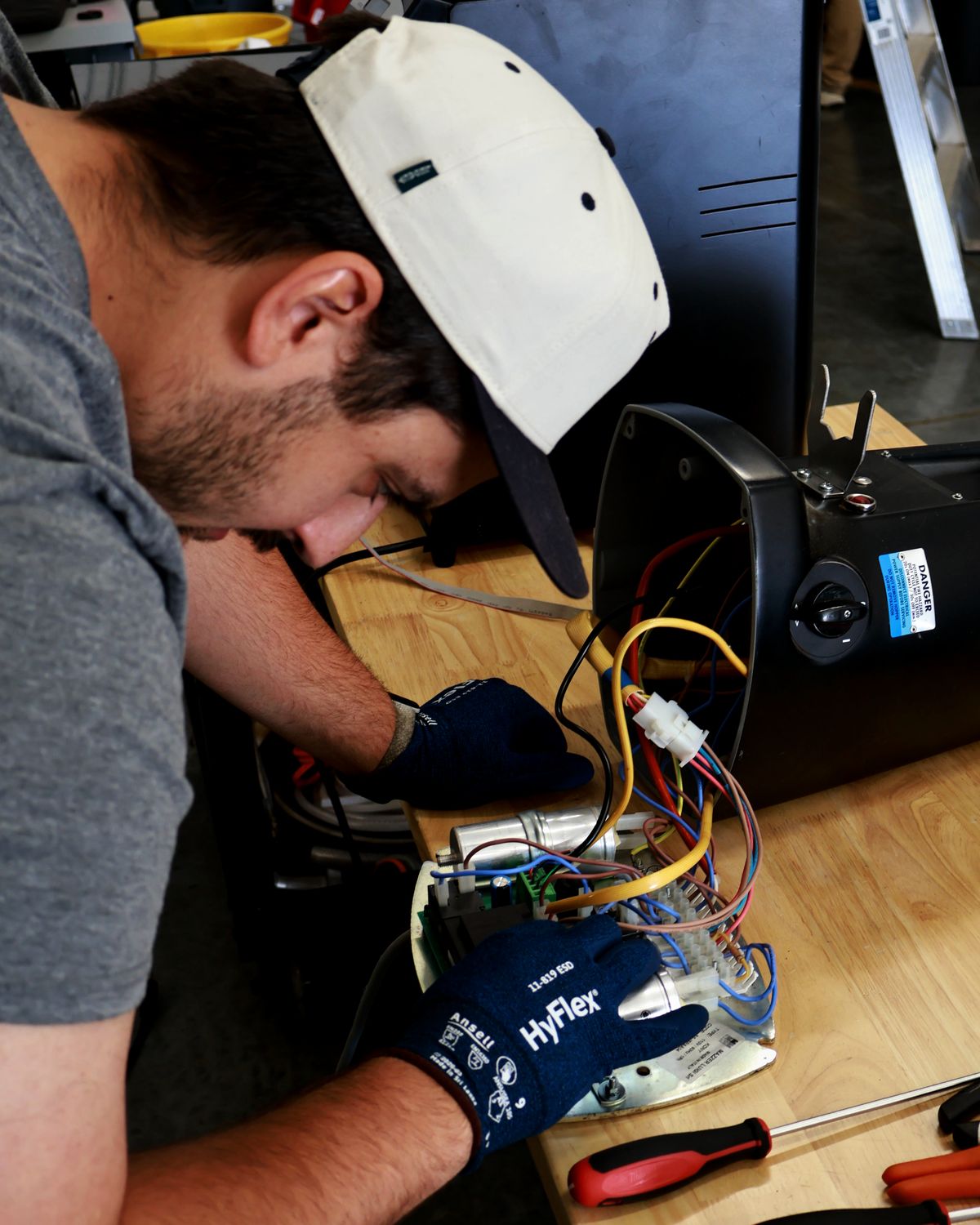 Cody repairing the wiring inside a commercial espresso machine